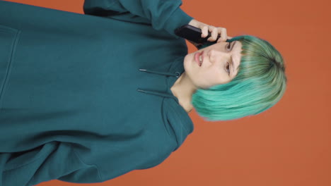 Vertical-video-of-Angry-young-woman-talking-on-the-phone.